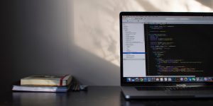 Computer on a desk with computer code open