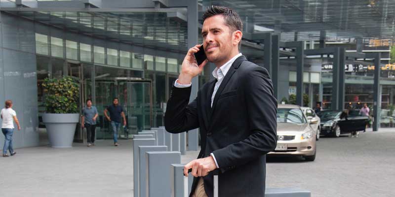 Man on Phone with Suitcase Man on Phone with Suitcase