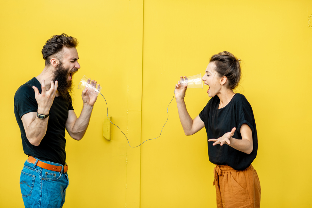 People speaking in plastic microphones